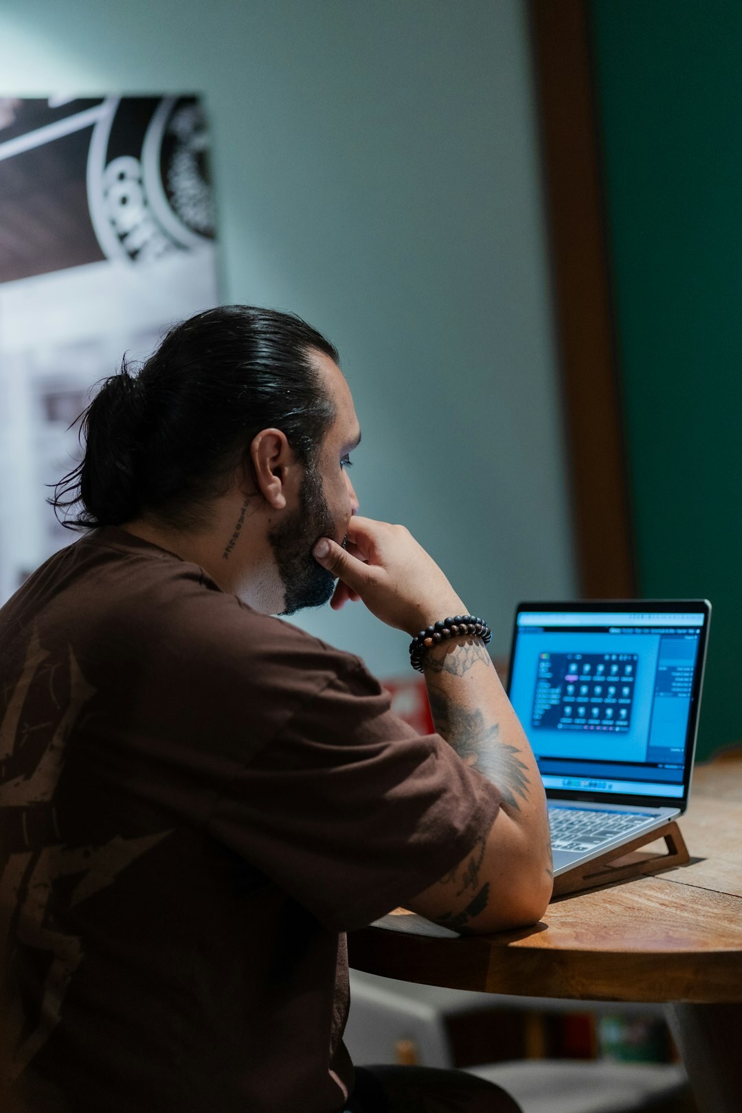 person coding on laptop at desk